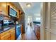 Kitchen featuring stainless steel appliances, granite countertops, wood cabinets, and view into the living area at 5722 Biscayne Ct # 107, New Port Richey, FL 34652