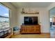 Living room with wood floors, TV, and a view of the marina from the window at 5722 Biscayne Ct # 107, New Port Richey, FL 34652