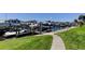 Picturesque marina view with boats docked in calm water, surrounded by lush green landscaping at 5722 Biscayne Ct # 107, New Port Richey, FL 34652