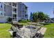Charming outdoor patio with grill, seating and picnic table overlooking the lush lawn and waterfront at 5722 Biscayne Ct # 107, New Port Richey, FL 34652