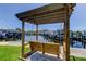 Waterfront swing with wood pergola and water views of boats in the marina at 5722 Biscayne Ct # 107, New Port Richey, FL 34652