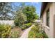 Lush backyard featuring a brick pathway, privacy fence, and mature landscaping at 5962 Lexington Dr, Parrish, FL 34219