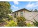 Beautifully landscaped backyard featuring lush greenery, stone pavers, and a fenced perimeter at 5962 Lexington Dr, Parrish, FL 34219