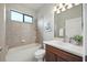 Bathroom with tiled shower and tub combination, a vanity with white countertop and cherry wood cabinets at 5962 Lexington Dr, Parrish, FL 34219