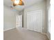Bedroom with neutral walls and carpeting features a ceiling fan, a closet, and a doorway to an adjacent room at 5962 Lexington Dr, Parrish, FL 34219