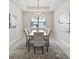 Dining room features a tray ceiling, large windows and neutral paint; complete with modern chandelier at 5962 Lexington Dr, Parrish, FL 34219