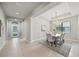 Dining room with tray ceilings, chandelier and large window; view of front entry at 5962 Lexington Dr, Parrish, FL 34219