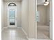 Bright foyer featuring tile floors, a decorative glass front door and a view into the adjacent bedroom at 5962 Lexington Dr, Parrish, FL 34219