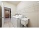 Functional laundry room featuring a washing machine, dryer, and utility sink at 5962 Lexington Dr, Parrish, FL 34219