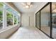 The sun room features large windows, tile flooring, and a sliding glass door at 5962 Lexington Dr, Parrish, FL 34219