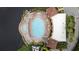 Aerial view showcases community pool and spa with seating, and surrounding landscaping at 6 Academy S Way # 221, St Petersburg, FL 33711