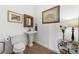 Cozy powder room features pedestal sink, decorative mirror and earth-toned tile floor at 6 Academy S Way # 221, St Petersburg, FL 33711