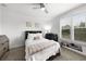 Cozy bedroom with a ceiling fan, a comfortable bed, and a view to the backyard at 6 Academy S Way # 221, St Petersburg, FL 33711
