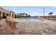 Community pool with ample pool deck, seating and lake view in sunny Florida at 6 Academy S Way # 221, St Petersburg, FL 33711