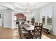 Open dining area includes chandelier, wood table with seating for six, and tiled flooring at 6 Academy S Way # 221, St Petersburg, FL 33711
