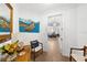 Inviting home foyer, featuring stylish furniture, artwork, and an open view into the dining area at 6 Academy S Way # 221, St Petersburg, FL 33711