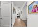 Hallway with tiled flooring leads to bedroom, displaying decorative art pieces at 6 Academy S Way # 221, St Petersburg, FL 33711