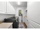 Efficient laundry room with modern washer and dryer, offering ample storage cabinets and a convenient utility sink at 6 Academy S Way # 221, St Petersburg, FL 33711