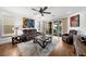 Cozy living room features leather seating, ceiling fan and views to screened patio at 6 Academy S Way # 221, St Petersburg, FL 33711