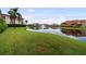 Beautiful water view of community with multiple buildings reflecting in the lake at 6 Academy S Way # 221, St Petersburg, FL 33711