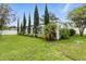 Beautifully landscaped backyard featuring manicured lawn, privacy landscaping, and mature trees at 6119 31St N Ave, St Petersburg, FL 33710