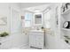Bright bathroom features a white vanity with modern fixtures and built-in shelving at 6119 31St N Ave, St Petersburg, FL 33710