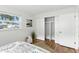 Bedroom featuring modern sliding closet doors, wood flooring, and natural light at 6119 31St N Ave, St Petersburg, FL 33710