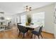 Open concept dining area with a white table, gray chairs, and plenty of natural light, seamlessly connected to other living spaces at 6119 31St N Ave, St Petersburg, FL 33710