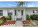 Inviting front entrance featuring white pillars, well-manicured landscaping, and a charming walkway at 6119 31St N Ave, St Petersburg, FL 33710