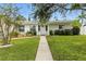 Cozy front porch with well-manicured landscaping and a charming walkway to a single story home at 6119 31St N Ave, St Petersburg, FL 33710