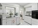 Bright white kitchen with stainless steel sink, appliances, and ample cabinet space at 6119 31St N Ave, St Petersburg, FL 33710