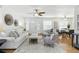 Open concept living room with hardwood floors, white sofa, dining area and modern decor, perfect for relaxing and entertaining guests at 6119 31St N Ave, St Petersburg, FL 33710