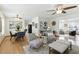 Open-concept living area with hardwood floors, ceiling fans, and a seamless flow into the dining area at 6119 31St N Ave, St Petersburg, FL 33710