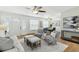 Spacious living room with open layout, natural light and stylish furnishings including a comfortable sofa, chairs, and a dining area at 6119 31St N Ave, St Petersburg, FL 33710