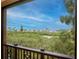Scenic balcony view showing lush vegetation with homes in the background and a cloudy blue sky at 6513 Sand Shore Ln, New Port Richey, FL 34652