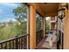 Relaxing outdoor balcony with seating, a view of trees, and a cozy atmosphere at 6513 Sand Shore Ln, New Port Richey, FL 34652