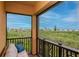 Seating area on a balcony overlooking a serene landscape filled with lush greenery at 6513 Sand Shore Ln, New Port Richey, FL 34652