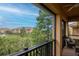 A screened balcony featuring comfortable outdoor seating with views of trees and nearby residential buildings at 6513 Sand Shore Ln, New Port Richey, FL 34652