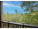 Balcony view featuring tree tops and blue sky at 6513 Sand Shore Ln, New Port Richey, FL 34652
