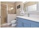 Nautical-themed bathroom with a walk-in shower, blue vanity, and white countertop at 6513 Sand Shore Ln, New Port Richey, FL 34652