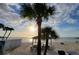 Stunning beach view featuring a covered picnic area, palm trees, and beautiful waterfront scenery at 6513 Sand Shore Ln, New Port Richey, FL 34652
