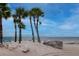 Enjoy the tranquility of the beach with azure chairs and a view of ocean and bright sky at 6513 Sand Shore Ln, New Port Richey, FL 34652