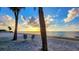 Charming beach view at sunset with azure chairs and white sand at 6513 Sand Shore Ln, New Port Richey, FL 34652