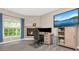 A well-lit desk area beside a fireplace, with a large window in the corner at 6513 Sand Shore Ln, New Port Richey, FL 34652