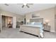 Spacious bedroom boasting neutral colors, a ceiling fan, and a connecting sitting room at 6513 Sand Shore Ln, New Port Richey, FL 34652