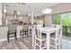 Dining area adjacent to modern kitchen with stainless appliances and lots of light from the outdoor area at 6513 Sand Shore Ln, New Port Richey, FL 34652