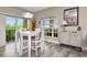 Open dining area with modern furniture, large windows, and access to an outdoor space at 6513 Sand Shore Ln, New Port Richey, FL 34652