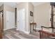 Bright entryway with neutral walls, wood-look floors, and a staircase leading to upper level at 6513 Sand Shore Ln, New Port Richey, FL 34652