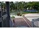 Beautiful walkway with mature trees and landscaping leading to community amenities at 6513 Sand Shore Ln, New Port Richey, FL 34652