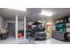 Spacious garage featuring a golf cart, ample storage, and epoxy flooring at 6513 Sand Shore Ln, New Port Richey, FL 34652